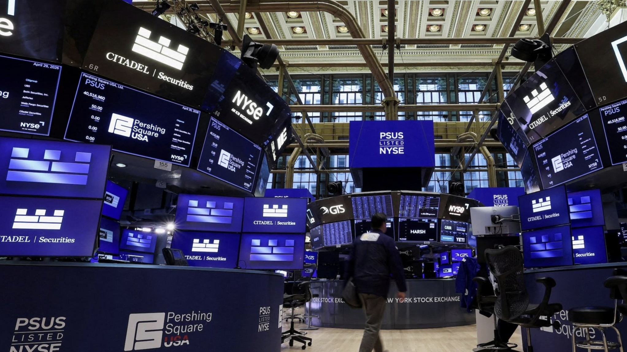 The NYSE trading floor. Index-level moves were contained while single-name dispersion widened sharply. Source: Reuters.