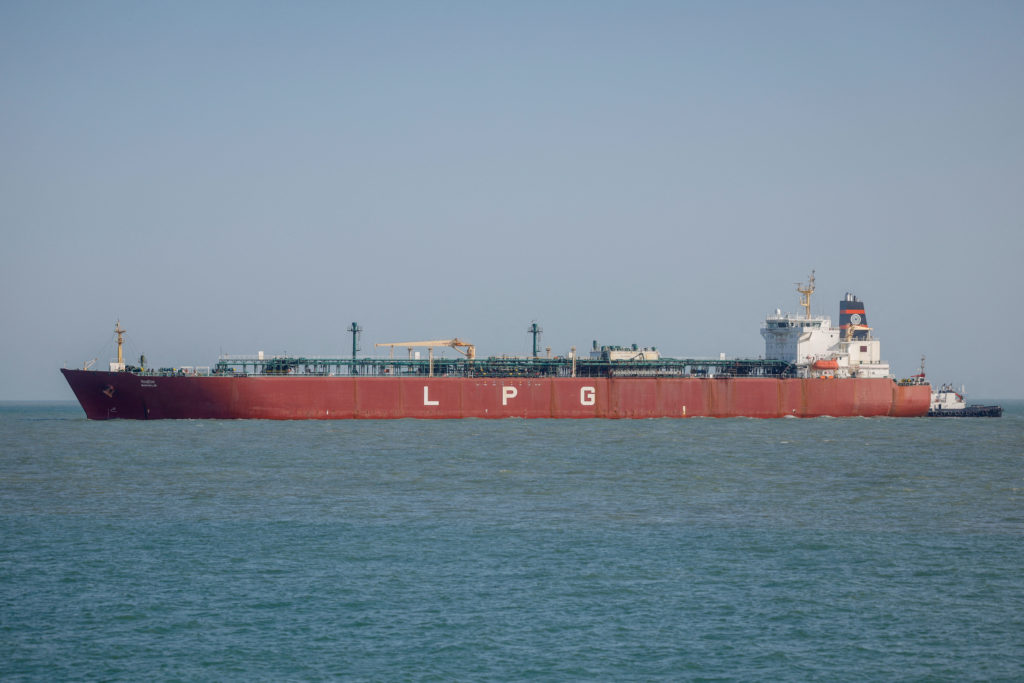 Tankers transit the Strait of Hormuz; Persian Gulf shipping neared a halt as US-Iran strikes escalated.  Source: PBS NewsHour / Reuters