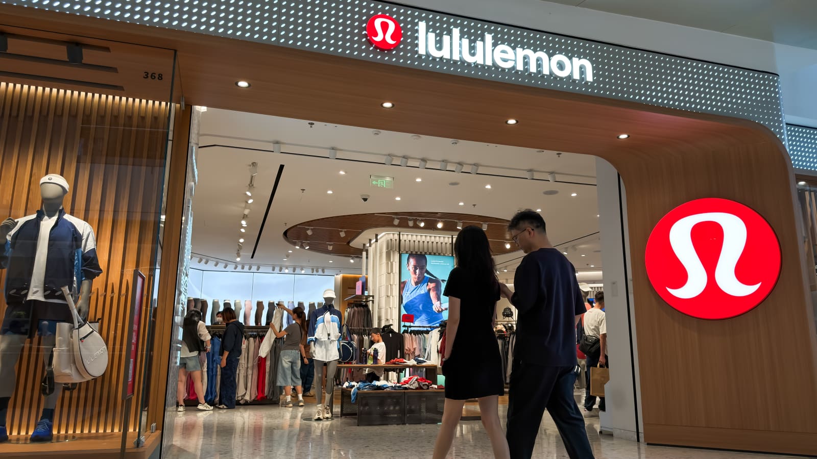 Lululemon cut FY26 to ~$11.0B with Americas comps −5% and tariff drag of 410bp on gross margin. International comps +13%. The U.S. consumer tell beneath the macro headline. Source: CNBC — Lululemon Q1 2026 earnings